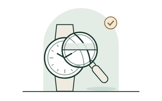 A watch under a loupe, with a brass tick