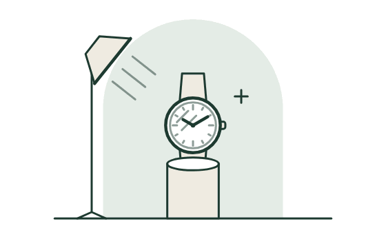 A watch on a stand under a soft lamp